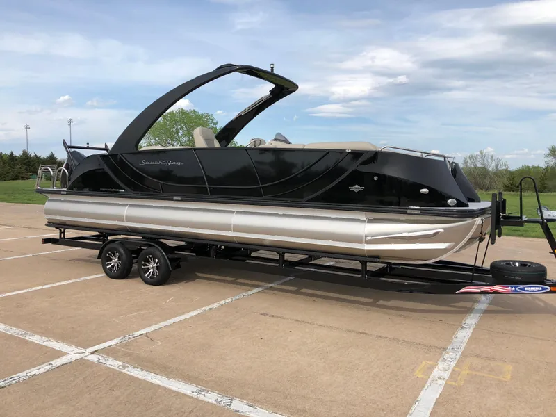 Slide: The Image of 2018 South Bay 25 Sport CR9 pontoon boat on trailer in parking lot. - 17