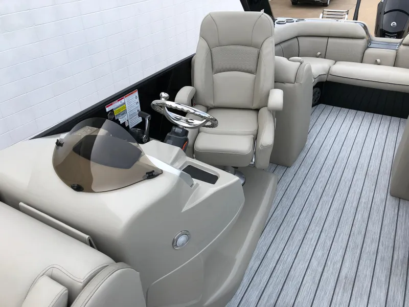 Slide: The Image of 2018 South Bay 25 Sport CR9 boat interior with helm, steering wheel, and seating. - 25