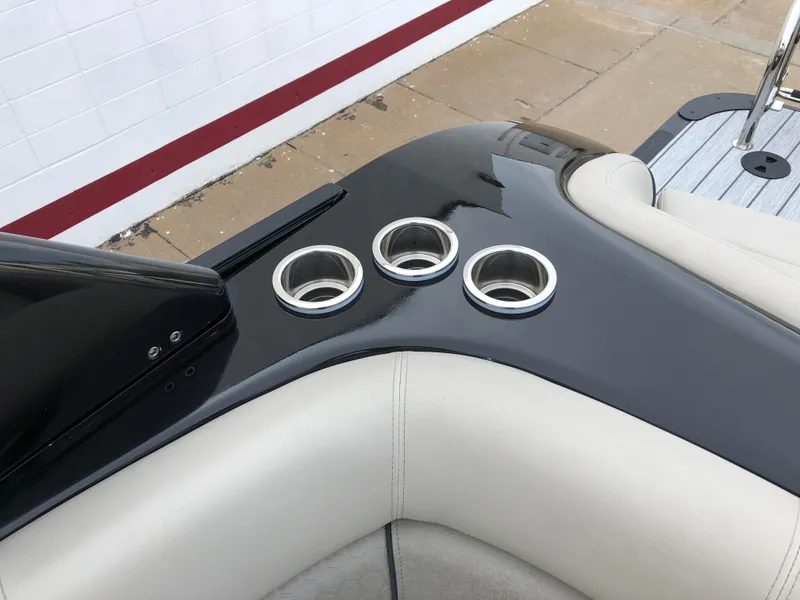 Slide: The Image of 2018 South Bay 25 Sport CR9 boat interior with cup holders and sleek design. - 29
