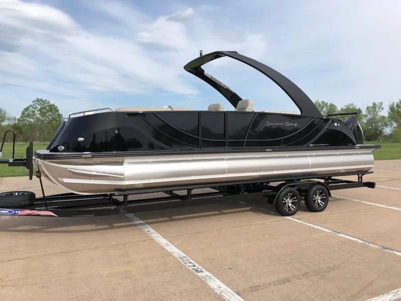 Slide: The Image of 2018 South Bay 25 Sport CR9 pontoon boat on trailer, parked outdoors. - 3