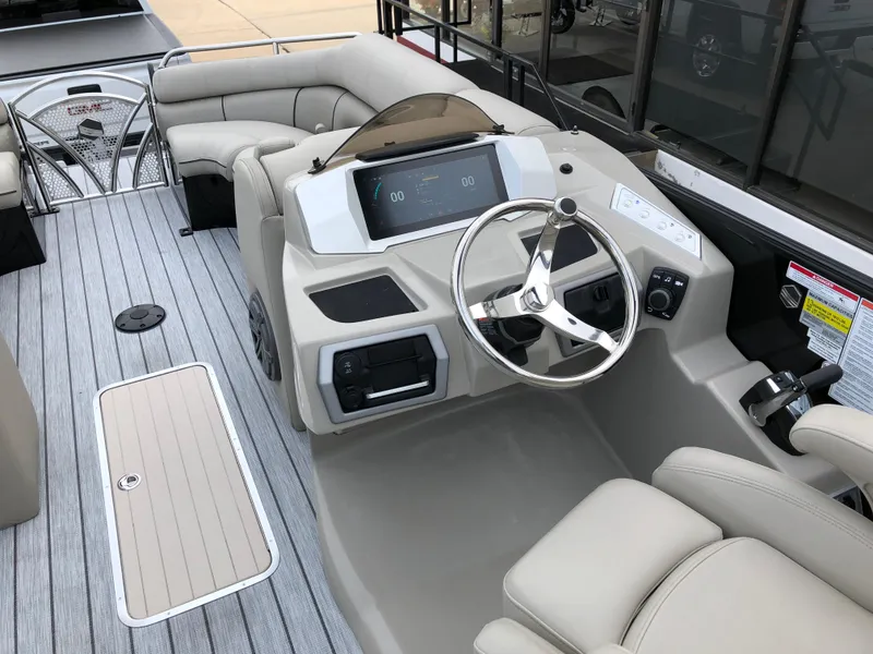 Slide: The Image of 2018 South Bay 25 Sport CR9 boat interior with steering wheel and seating area. - 32
