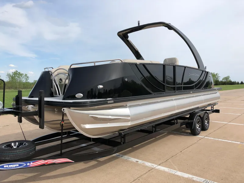 Slide: The Image of 2018 South Bay 25 Sport CR9 pontoon boat on a trailer in a parking lot. - 5