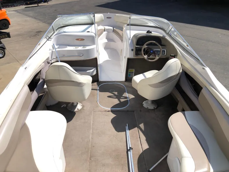 Slide: The Image of 1997 Four Winns 240 Horizon boat interior with seating and steering wheel. - 3