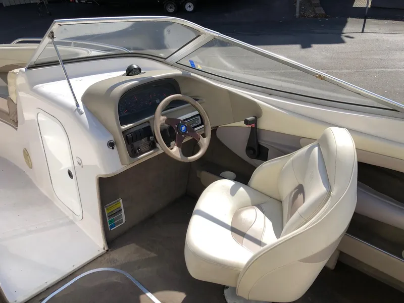 Slide: The Image of 1997 Four Winns 240 Horizon boat interior with steering wheel and captain's chair. - 4