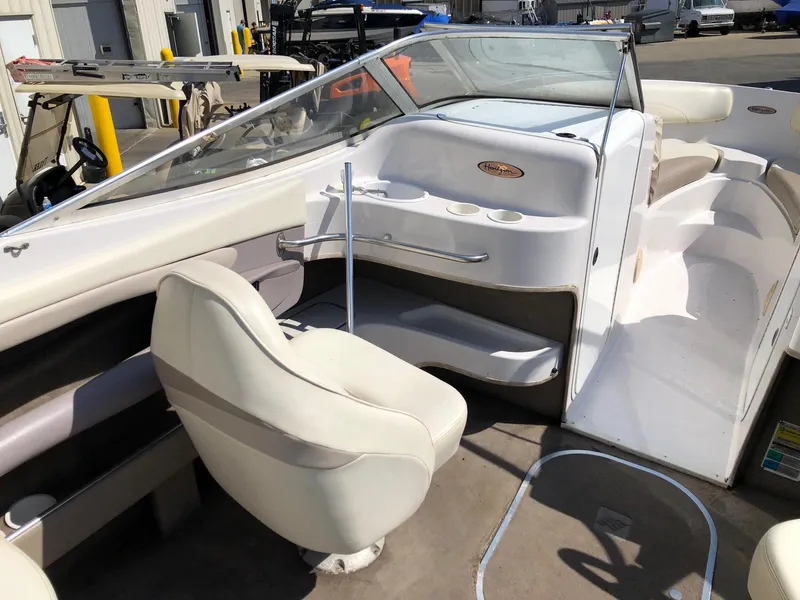 Slide: The Image of 1997 Four Winns 240 Horizon boat interior with white seating and dashboard. - 5