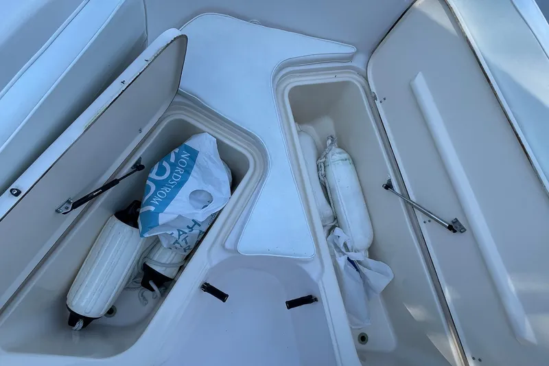 Slide: The Image of Storage compartments on a 1999 Grady-White 209 ESCAPE boat with fenders and a bag. - 13