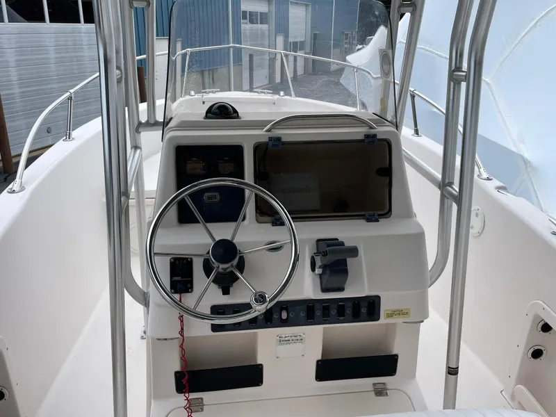 Slide: The Image of 1999 Grady-White 209 ESCAPE boat dashboard with steering wheel and controls. - 2