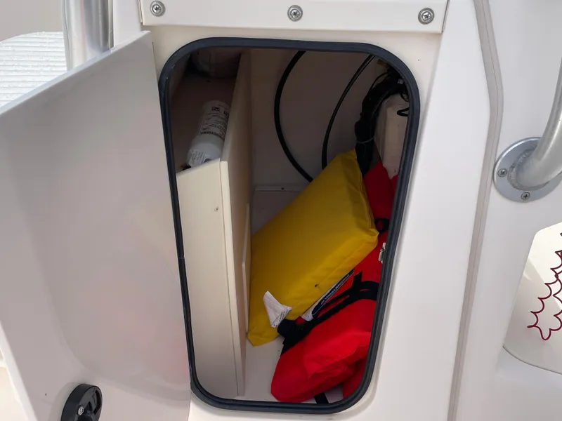 Slide: The Image of Open storage compartment on 1999 Grady-White 209 ESCAPE boat with safety equipment. - 9