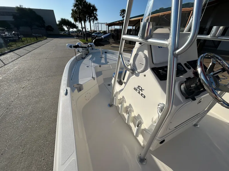 Slide: The Image of 2016 Skeeter SX 210 boat, white interior, steering console, sunny outdoor setting. - 10