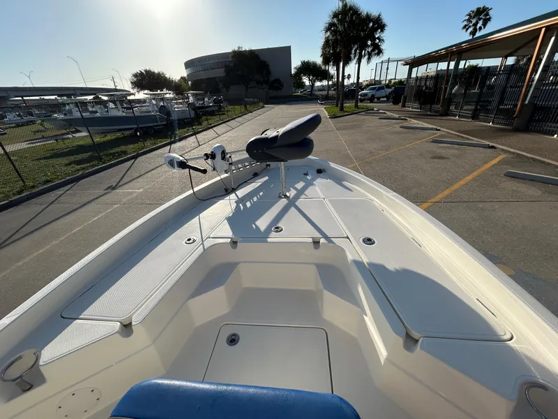 Slide: The Image of 2016 Skeeter SX 210 boat parked in marina with clear sky and palm trees. - 12
