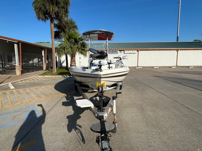 Slide: The Image of 2016 Skeeter SX 210 boat on trailer in sunny parking lot. - 2