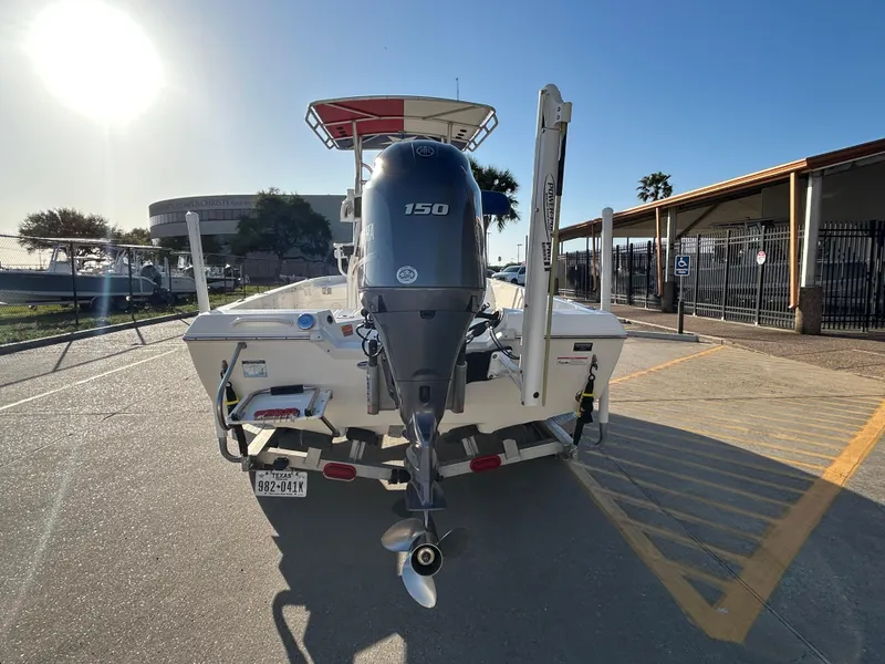 Slide: The Image of 2016 Skeeter SX 210 boat with 150 HP engine on a trailer, parked outdoors. - 6