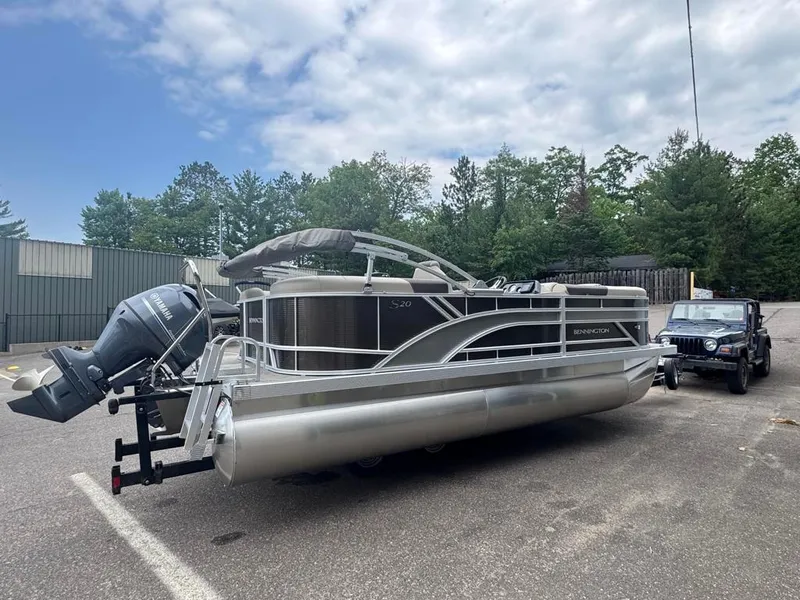 Slide: The Image of 2025 Bennington 20SSR pontoon boat with Yamaha engine, parked outdoors. - 4