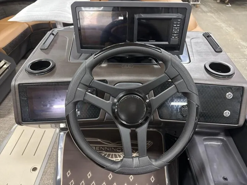 Slide: The Image of Steering console of 2025 Bennington 22MSB-SPS boat with dual screens and cup holders. - 10