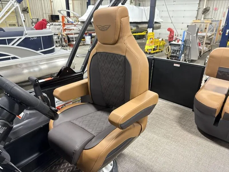 Slide: The Image of Luxurious seating on 2025 Bennington 22MSB-SPS boat, featuring tan and black upholstery. - 11
