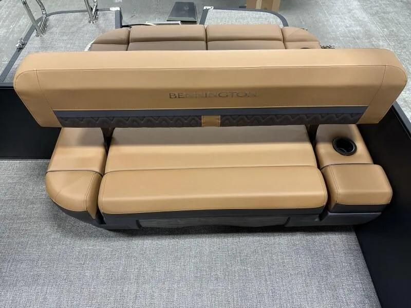 Slide: The Image of 2025 Bennington 22MSB-SPS boat seating with tan upholstery and cup holder. - 9