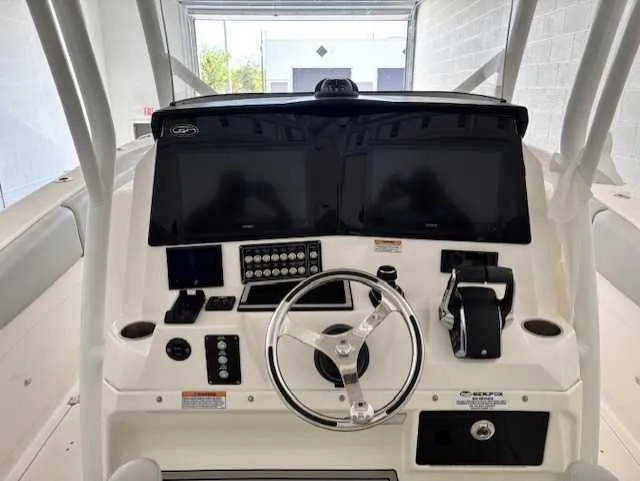 Slide: The Image of 2023 Sea Fox 328 Commander helm with dual displays and modern controls. - 13