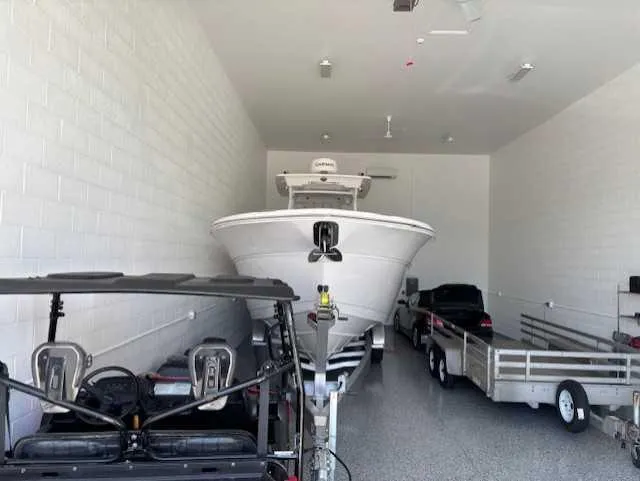 Slide: The Image of 2023 Sea Fox 328 Commander boat in garage with vehicles and trailer. - 14