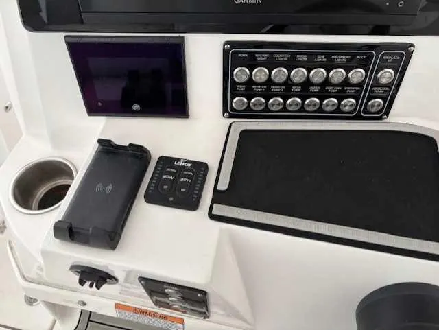 Slide: The Image of Control panel of 2023 Sea Fox 328 Commander boat with switches and electronic devices. - 6