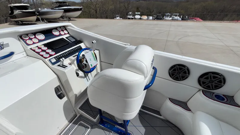 Slide: The Image of 1993 Cigarette 38 Top Gun boat cockpit with white seating and control panel. - 16
