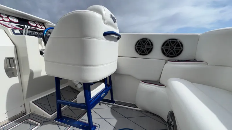 Slide: The Image of Interior of a 1993 Cigarette 38 Top Gun boat with white seating and blue accents. - 22