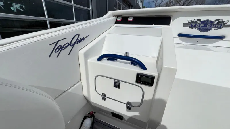 Slide: The Image of 1993 Cigarette 38 Top Gun boat interior with "Top Gun" branding and storage compartment. - 23