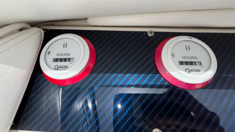 Slide: The Image of Hour meters on a 1993 Cigarette 38 Top Gun boat dashboard with carbon fiber finish. - 25