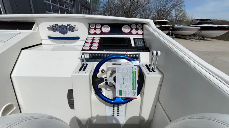 Slide: The Image of 1993 Cigarette 38 Top Gun boat dashboard with steering wheel and control panel. - 29