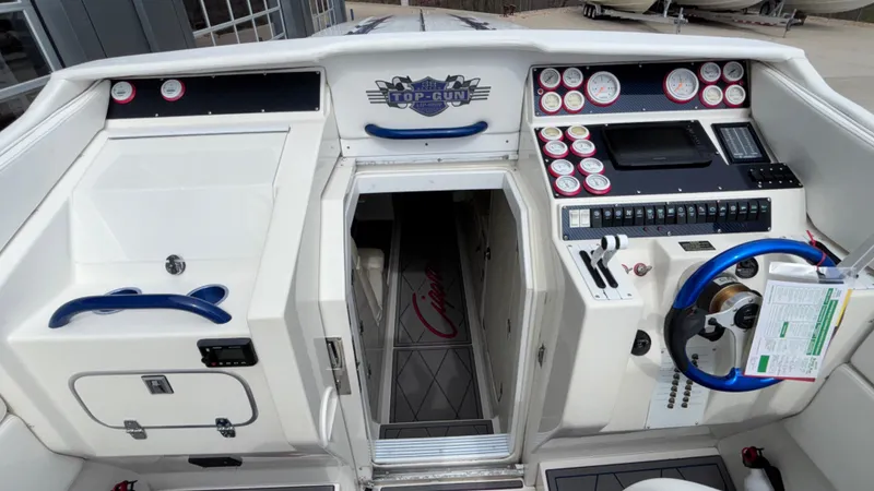 Slide: The Image of 1993 Cigarette 38 Top Gun boat cockpit with control panel and steering wheel. - 30