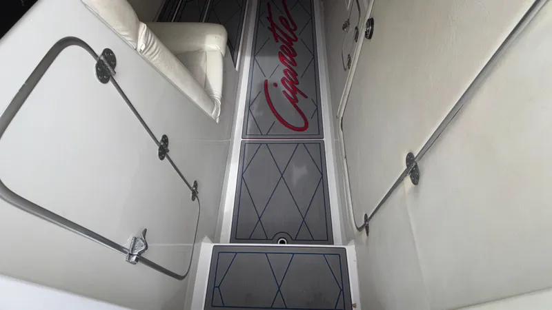 Slide: The Image of 1993 Cigarette 38 Top Gun boat interior with branded flooring and white seating. - 32