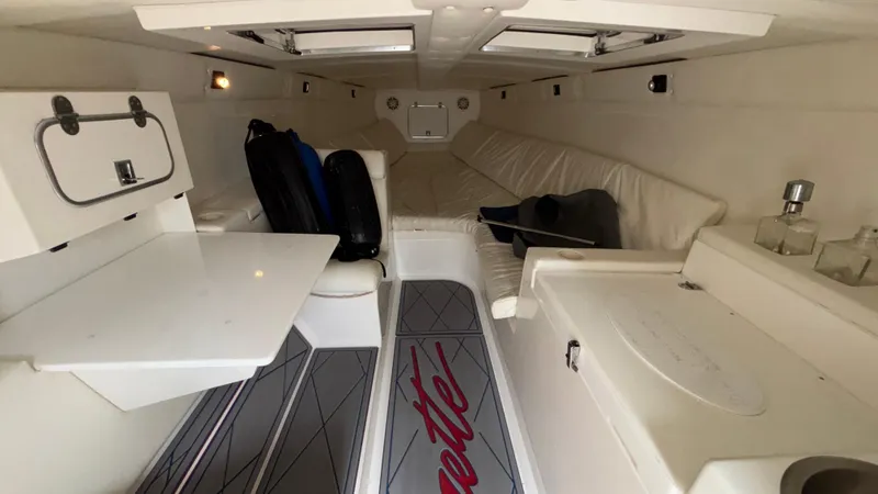 Slide: The Image of Interior of a 1993 Cigarette 38 Top Gun boat, featuring white seating and compact design. - 33