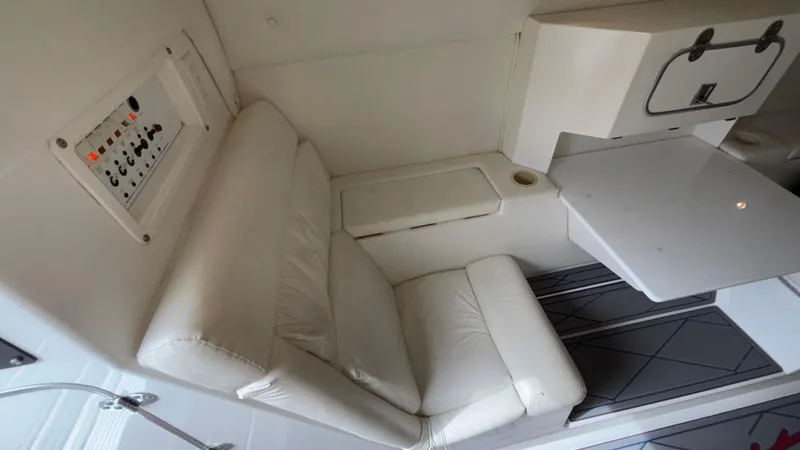 Slide: The Image of 1993 Cigarette 38 Top Gun cabin interior with white seating and control panel. - 35