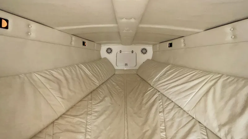 Slide: The Image of Interior cabin of a 1993 Cigarette 38 Top Gun boat, featuring beige upholstery. - 36