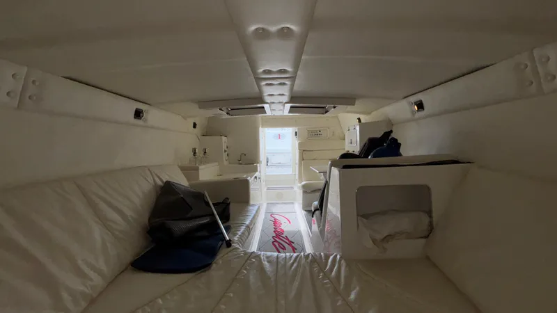 Slide: The Image of Interior of a 1993 Cigarette 38 Top Gun boat, featuring white seating and compact design. - 37