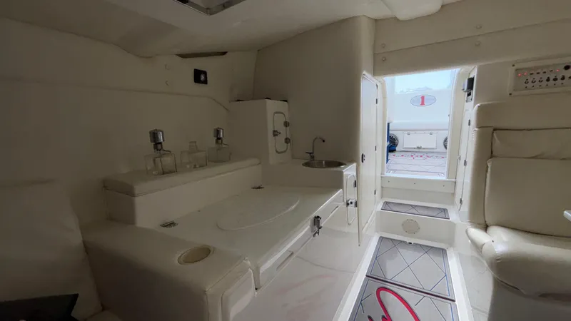 Slide: The Image of Interior of a 1993 Cigarette 38 Top Gun boat, featuring white seating and modern amenities. - 40