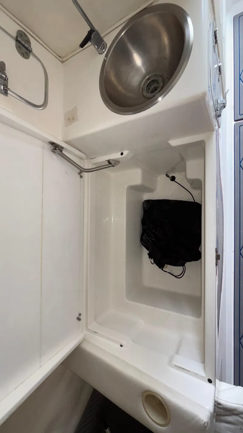 Slide: The Image of 1993 Cigarette 38 Top Gun boat interior with sink and storage area. - 41