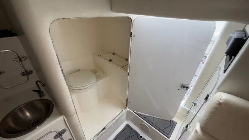 Slide: The Image of Interior of 1993 Cigarette 38 Top Gun boat featuring compact bathroom and sink area. - 42