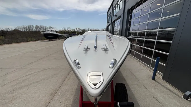 Slide: The Image of 1993 Cigarette 38 Top Gun boat on trailer, parked outside a modern building. - 6