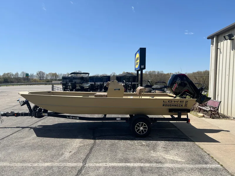 Slide: The Image of 2025 Lowe Roughneck 2070 CC boat on trailer in parking lot, sunny day. - 4