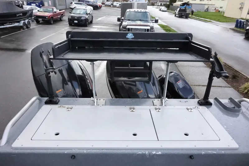 Slide: The Image of 2015 Duckworth 26 Offshore boat with dual outboard motors in a parking lot. - 12