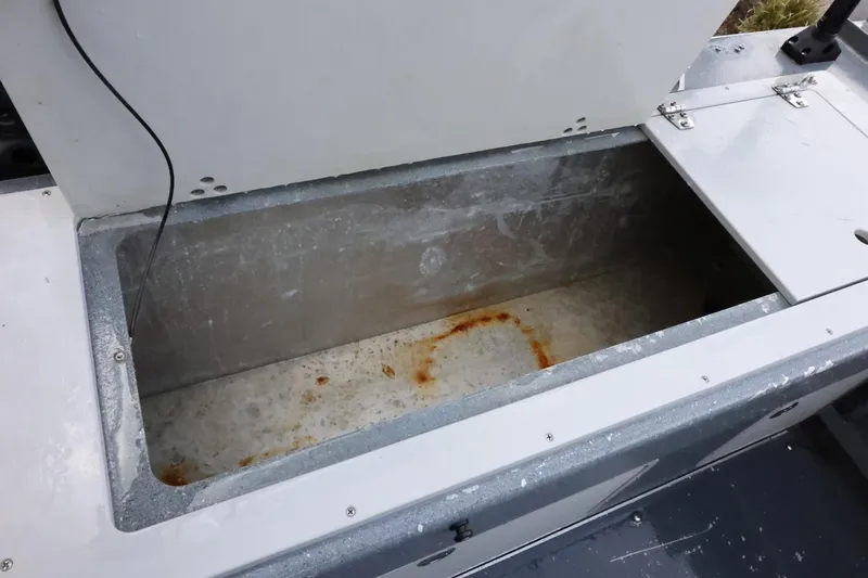 Slide: The Image of Open storage compartment on a 2015 Duckworth 26 Offshore boat, showing interior condition. - 13