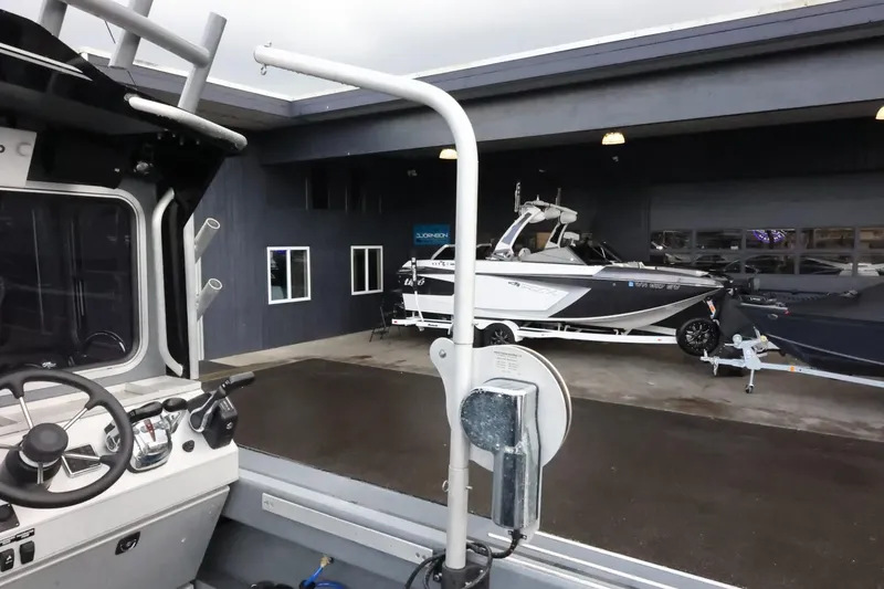 Slide: The Image of 2015 Duckworth 26 Offshore boat at a dealership, with another boat in the background. - 16