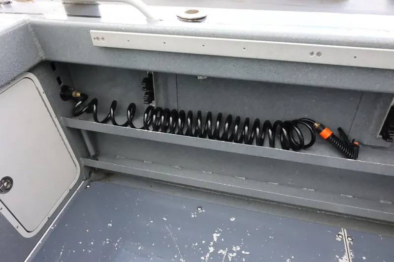 Slide: The Image of 2015 Duckworth 26 Offshore boat interior with coiled hose storage. - 17