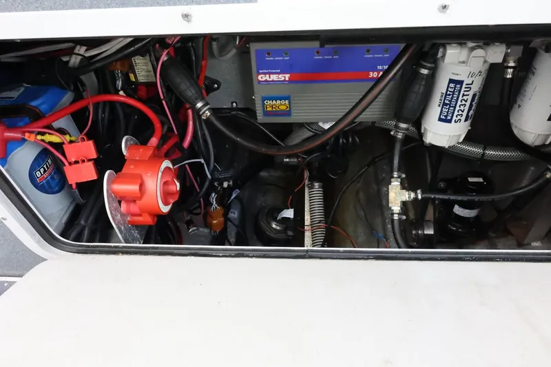Slide: The Image of Engine compartment of a 2015 Duckworth 26 Offshore boat, featuring wiring and battery components. - 18