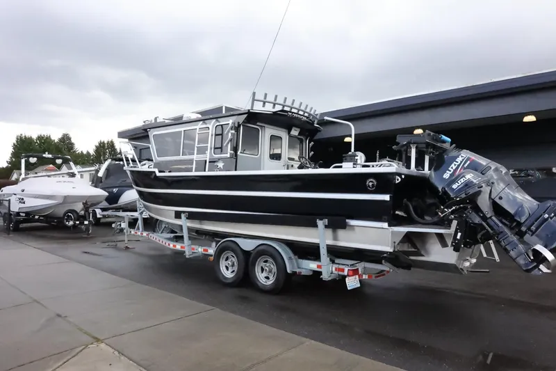 Slide: The Image of 2015 Duckworth 26 Offshore boat on trailer, parked outdoors, with overcast sky. - 2