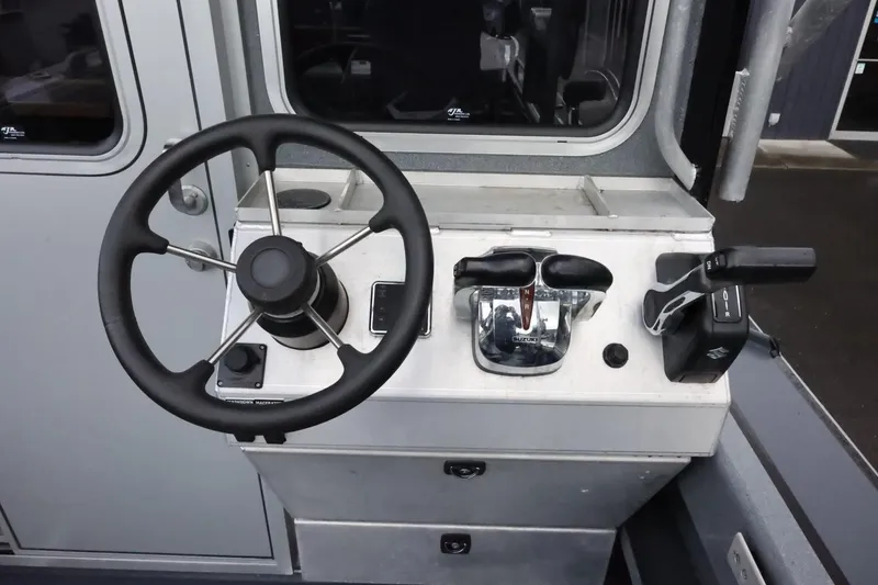 Slide: The Image of 2015 Duckworth 26 Offshore boat helm with steering wheel and controls. - 21