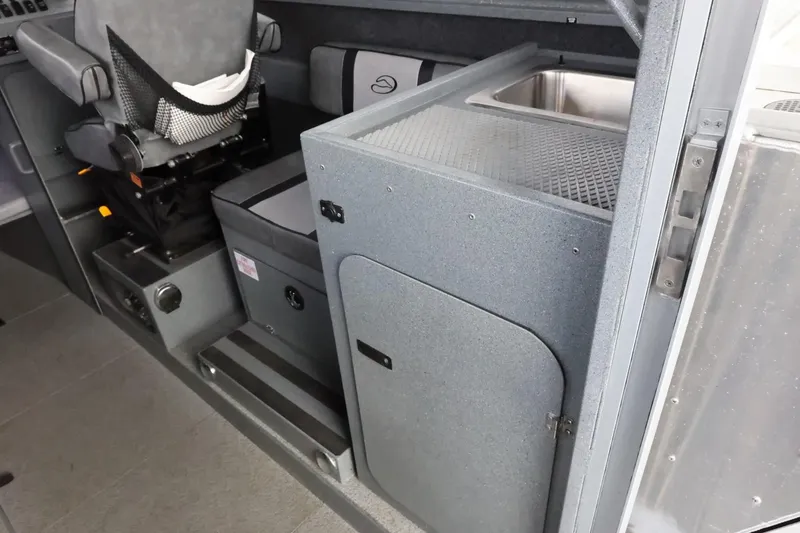 Slide: The Image of 2015 Duckworth 26 Offshore interior with seating and storage area. - 28