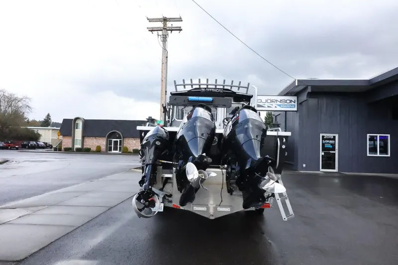 Slide: The Image of 2015 Duckworth 26 Offshore boat with dual outboard motors parked outside a dealership. - 3