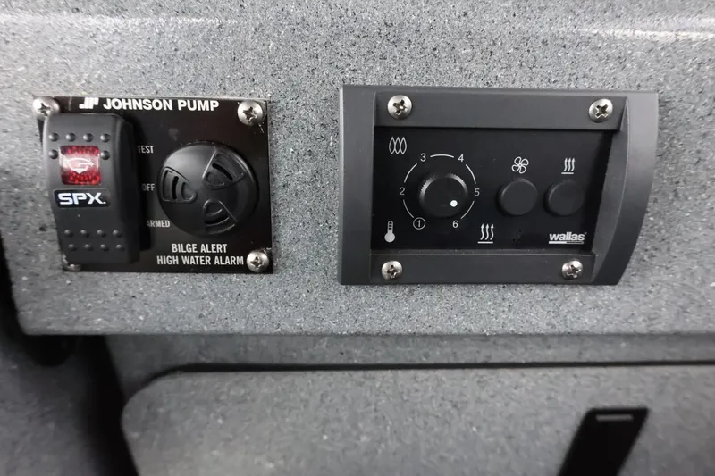 Slide: The Image of Control panel of a 2015 Duckworth 26 Offshore boat with bilge alert and heater controls. - 41