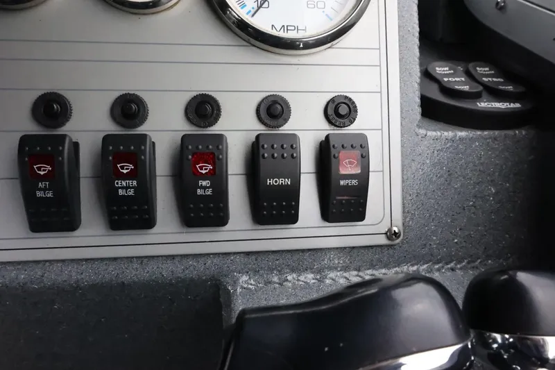 Slide: The Image of Control panel of a 2015 Duckworth 26 Offshore boat with switches for bilge, horn, and wipers. - 42